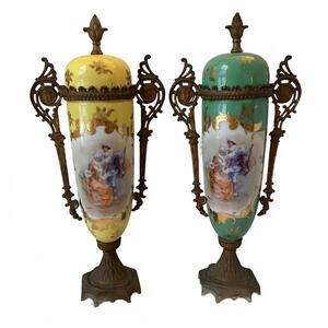 A pair of artist-signed Royal Vienna urn vases with ormolu mounts.